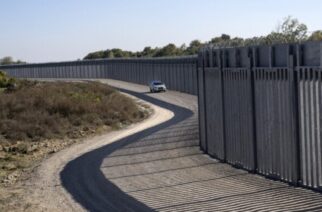 FILE - A police border vehicle patrols along a border wall near the town of Feres, along the Evros River which forms the frontier between Greece and Turkey on Sunday, Oct. 30, 2022. Greece prevented some 260,000 migrants from entering illegally in 2022 and arrested 1,500 traffickers, Greece's minister in charge of the security told ambassadors from other European Union countries plus Switzerland and the United Kingdom Saturday, Jan. 21,2023, as he guided them to a still expanding border wall in the country's northeast. (AP Photo/Petros Giannakouris, File)